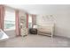 Serene Bedroom with a crib, rocking chair, and pink accents at 1636 Tundra Ln, Denver, NC 28037