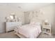 Bright bedroom with a decorative mirror, dresser, and soft pink accents at 1636 Tundra Ln, Denver, NC 28037