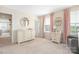 Bright Bedroom featuring a changing table, plush carpet, and soft pink accents at 1636 Tundra Ln, Denver, NC 28037
