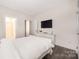 Clean and bright bedroom with hardwood floors and a mounted TV at 1636 Tundra Ln, Denver, NC 28037