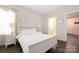 Bright bedroom with white furniture, hardwood floors, and a calming aesthetic at 1636 Tundra Ln, Denver, NC 28037