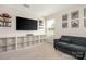 Cozy bonus room with a large TV, sofa, and ample storage space at 1636 Tundra Ln, Denver, NC 28037