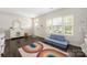 Comfortable bonus room featuring a rainbow rug and sofa at 1636 Tundra Ln, Denver, NC 28037