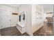 Welcoming entryway featuring a built-in bench, shoe storage, coat hooks, and hardwood floors at 1636 Tundra Ln, Denver, NC 28037