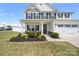 Inviting home entrance featuring a covered porch, manicured landscaping, and stylish exterior details at 1636 Tundra Ln, Denver, NC 28037