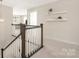 Upstairs hallway with carpet, shelf decor and wooden railings at 1636 Tundra Ln, Denver, NC 28037