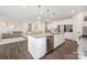 Spacious kitchen features stainless appliances, a granite island with bar seating, and modern pendant lighting at 1636 Tundra Ln, Denver, NC 28037
