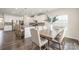Bright, open kitchen with white cabinets, stainless steel appliances, and a large island with bar seating at 1636 Tundra Ln, Denver, NC 28037