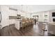 Open kitchen flows into living area, featuring granite counters, pendant lights and seating at the kitchen island at 1636 Tundra Ln, Denver, NC 28037