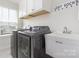 Functional laundry room with modern washer/dryer and utility sink at 1636 Tundra Ln, Denver, NC 28037