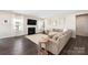 Comfortable living room with a fireplace, large sectional sofa, and hardwood floors at 1636 Tundra Ln, Denver, NC 28037