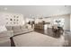 Spacious living room and kitchen area with hardwood floors, neutral tones, and ample natural light at 1636 Tundra Ln, Denver, NC 28037