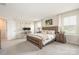 Spacious bedroom with a wooden bed, two bedside tables, and two large windows at 1636 Tundra Ln, Denver, NC 28037