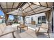 Inviting covered patio with neutral furniture, barbecue, and playset for outdoor enjoyment at 1636 Tundra Ln, Denver, NC 28037