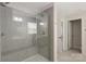 Sleek shower featuring glass door, tile walls, and modern fixtures at 1636 Tundra Ln, Denver, NC 28037
