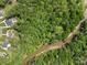 Aerial view displaying lush greenery and water flowing nearby several homes at 1655 Buckland Ct, Indian Land, SC 29707