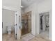 Well lit bathroom featuring a glass enclosed shower and open doorway to the main bedroom at 1655 Buckland Ct, Indian Land, SC 29707