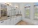 Elegant bathroom with dual sinks, granite countertops, and a large mirror at 1655 Buckland Ct, Indian Land, SC 29707