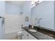 Full bathroom featuring light blue walls, a shower and tub combo, a dark countertop, and a white vanity at 1655 Buckland Ct, Indian Land, SC 29707