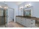 Bathroom with a large double vanity, tiled shower, neutral color palette, and tiled floors at 1655 Buckland Ct, Indian Land, SC 29707