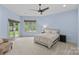 Spacious bedroom with two windows and a sliding glass door and with neutral tones, and a ceiling fan at 1655 Buckland Ct, Indian Land, SC 29707