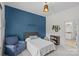 Cozy bedroom with a blue accent wall, carpeted floors, chair and a comfortable bed creates a peaceful retreat at 1655 Buckland Ct, Indian Land, SC 29707