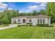 Beautifully landscaped one-story home with mature trees and a circular driveway at 1655 Buckland Ct, Indian Land, SC 29707