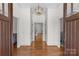 Inviting foyer with beautiful hardwood floors, statement lighting, and neutral walls creating a seamless flow throughout the home at 1655 Buckland Ct, Indian Land, SC 29707