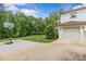 Exterior view of the attached garage with a spacious driveway and a basketball court at 1655 Buckland Ct, Indian Land, SC 29707