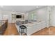 Spacious living room with built-in shelving, white sofa, and hardwood floors at 1655 Buckland Ct, Indian Land, SC 29707