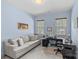 Comfortable home office with a light blue wall, plush sofa, and a modern black desk with drawers at 1655 Buckland Ct, Fort Mill, SC 29707
