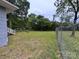 Large backyard area with grass, trees, and a partial view of the home's rear exterior at 1703 Lowder St, Albemarle, NC 28001