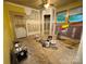 Unfinished living room with bare floors and painting supplies at 1703 Lowder St, Albemarle, NC 28001