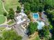 Stunning aerial view of a community with a golf course, clubhouse, and multiple pools surrounded by lush greenery at 173 Greenridge Rd, Lake Wylie, SC 29710
