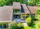 An aerial view showcasing the back of the house with a back patio and lush green trees at 173 Greenridge Rd, Lake Wylie, SC 29710