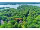 An aerial view shows the home situated among lush trees near a large lake at 173 Greenridge Rd, Lake Wylie, SC 29710