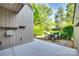 View of a back patio with chairs and table surrounded by lush green trees at 173 Greenridge Rd, Lake Wylie, SC 29710