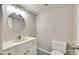 Clean and simple bathroom featuring a white vanity, round mirror, and toilet at 173 Greenridge Rd, Lake Wylie, SC 29710