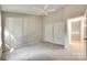 This bedroom features neutral walls, gray carpet, a ceiling fan, and a double door closet for ample storage at 173 Greenridge Rd, Lake Wylie, SC 29710