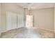 This bedroom has neutral walls, gray carpet, a ceiling fan, and a double door closet for ample storage at 173 Greenridge Rd, Lake Wylie, SC 29710