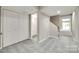 Hallway featuring a closet, bathroom, and staircase, offering convenient access to different areas of the home at 173 Greenridge Rd, Lake Wylie, SC 29710