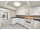 Well-lit kitchen featuring white cabinets, stone countertops, and modern appliances at 173 Greenridge Rd, Lake Wylie, SC 29710