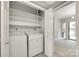 Convenient laundry closet with washer, dryer, and shelving for storage at 173 Greenridge Rd, Lake Wylie, SC 29710