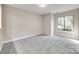 Well-lit living area features neutral-colored walls, tile flooring, and a large window for plenty of natural light at 173 Greenridge Rd, Lake Wylie, SC 29710