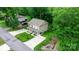 Beautiful aerial view of a two-story home with a long driveway and a lush green yard surrounded by mature trees at 1735 15Th Street Ne Pl, Hickory, NC 28601