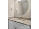Bathroom with granite countertops, oval mirror, and brushed nickel faucet at 1735 15Th Street Ne Pl, Hickory, NC 28601