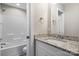 Bathroom featuring a granite-topped vanity, a mirror, a tub-shower combo, and an adjacent toilet at 1735 15Th Street Ne Pl, Hickory, NC 28601