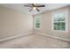 Sunlit bedroom with carpeted floors, a ceiling fan, and two windows offering neighborhood views at 1735 15Th Street Ne Pl, Hickory, NC 28601