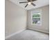Bright bedroom with carpeted floors, a ceiling fan, and a window overlooking the neighborhood at 1735 15Th Street Ne Pl, Hickory, NC 28601