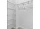 Walk-in closet featuring carpeted floors and multiple tiers of wire shelving for optimal storage solutions at 1735 15Th Street Ne Pl, Hickory, NC 28601
